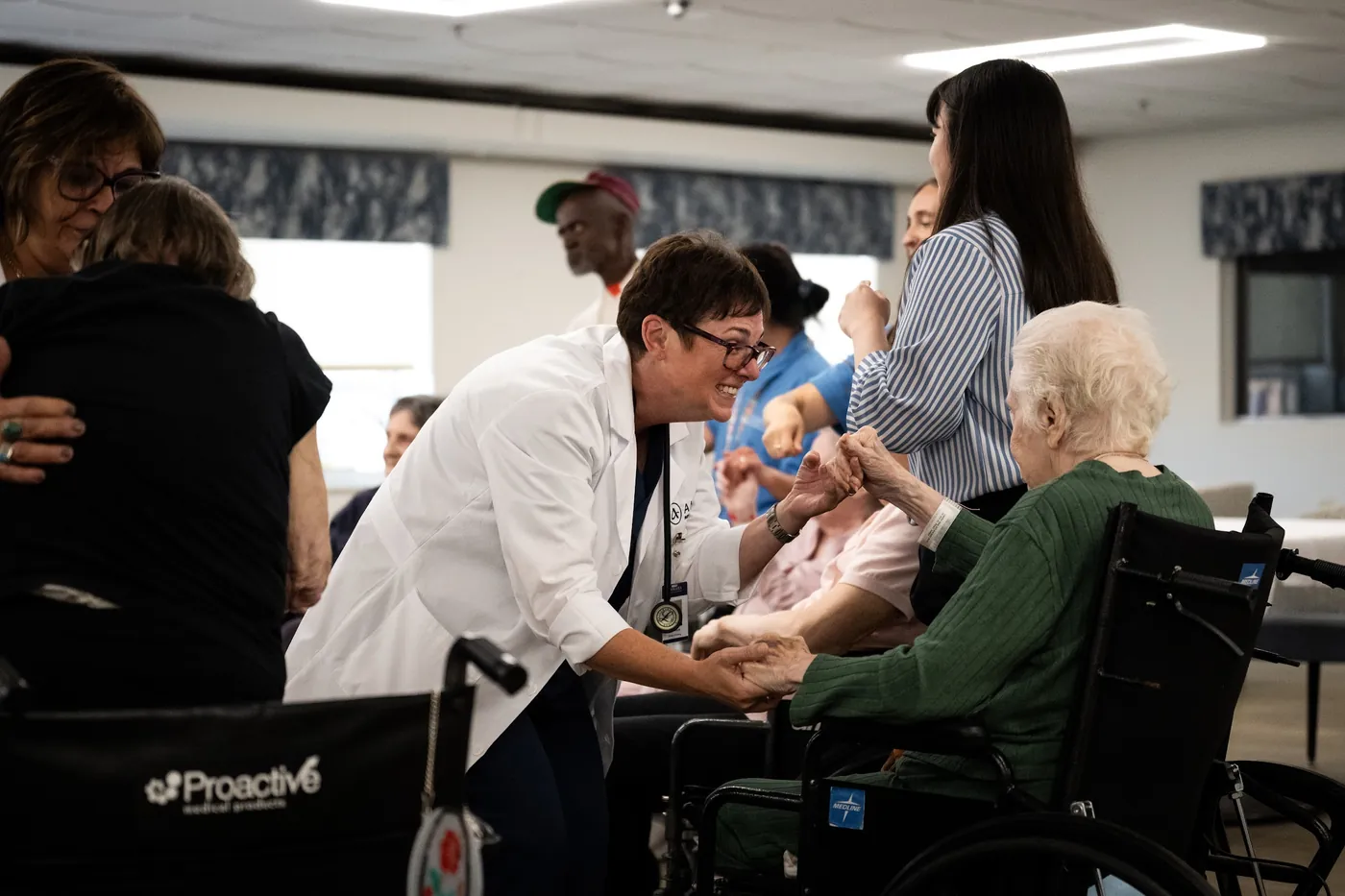 Clinician smiling with a resident during an activity in the dayroom