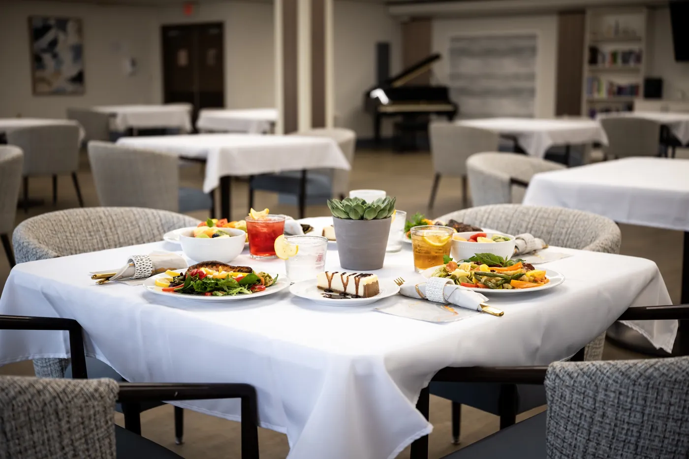 Dining table set with freshly plated meals and drinks