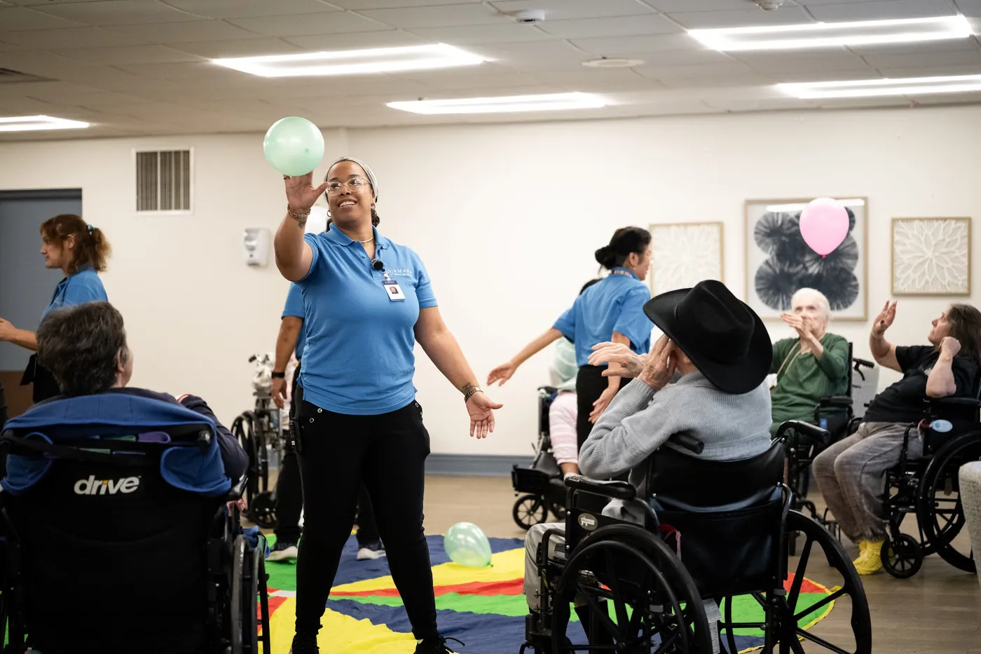 Care team members engaging residents during a group activity