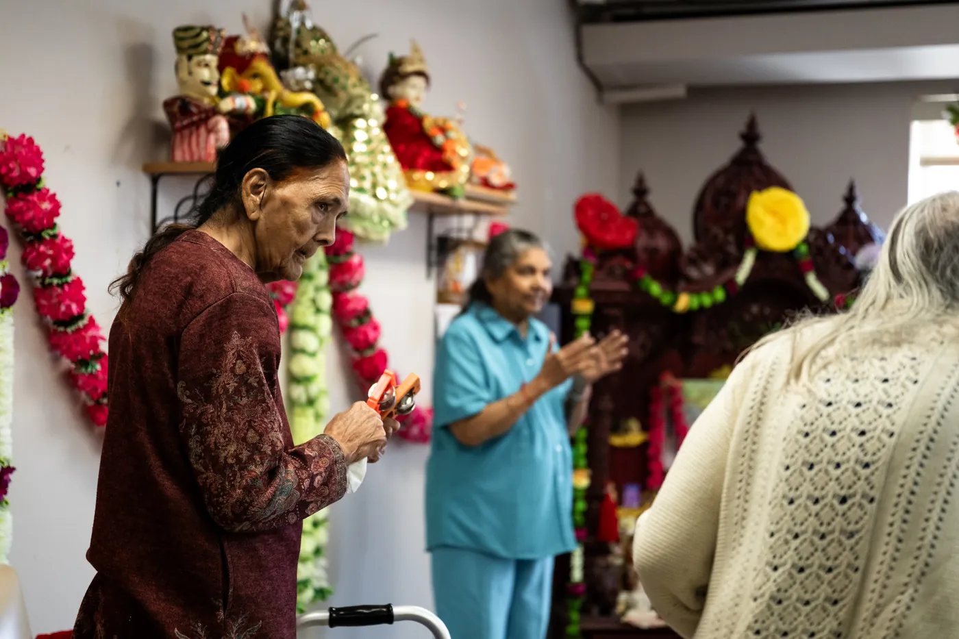 Two residents wearing flower garlands during a festival celebration