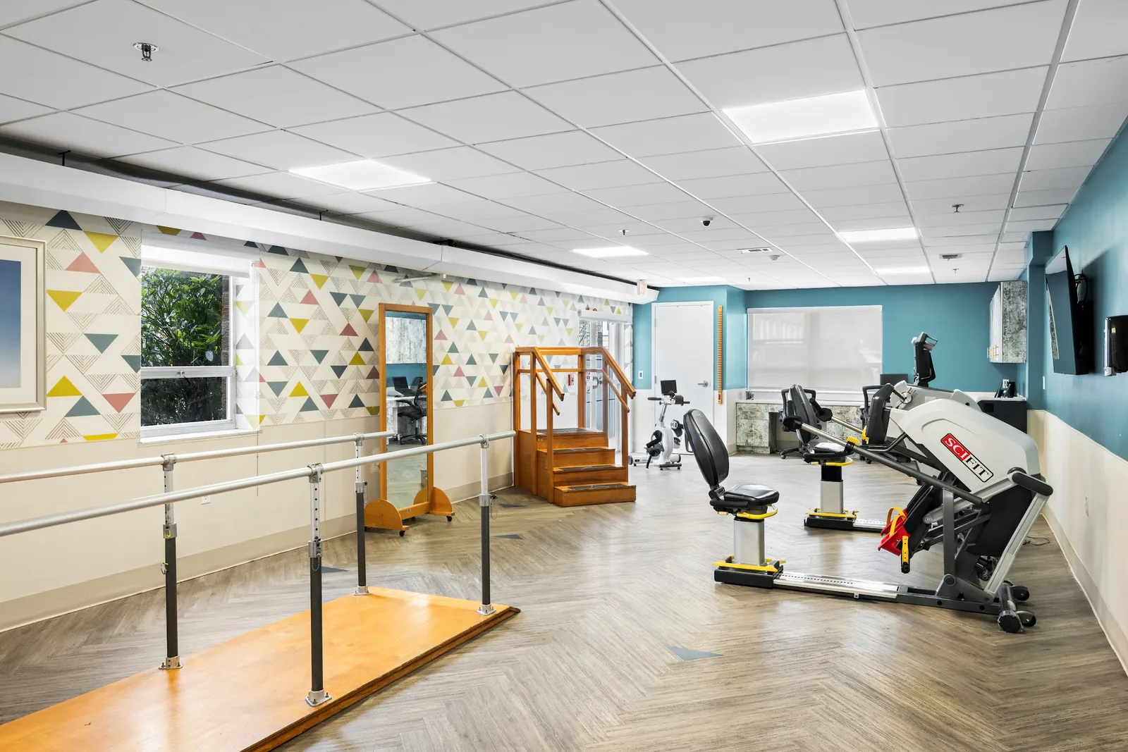 Rehabilitation gym with parallel bars, training stairs and exercise equipment